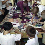 Different group of children making collage on table